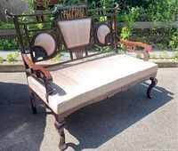 Full view of antique pagoda style settee with upholstered seat and back cushion showing overall design and condition.