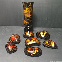 Single black lacquered vase with gilded nature scene featuring birds and plants, standing upright.