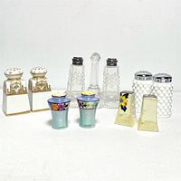 Full view of all 11 assorted salt and pepper shakers showing various styles and materials.