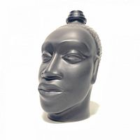 Front view of the matte black sculpted head oil diffuser showing facial details and top cap.