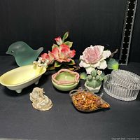 Photo of miscellaneous porcelain lot showing all items together on black background with ruler for scale.