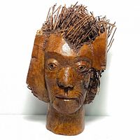 Front view of the bamboo root carved head sculpture showing detailed facial features and textured root twig hair.