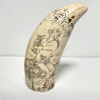 Front view of sperm whale tooth scrimshaw with figure playing lyre