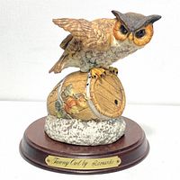 Front and left side view of the tawny owl porcelain figurine showing detailed hand painting and brass plaque on wood base.
