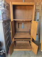 Close-up view of middle section with doors open revealing built-in light and power strip, and adjustable shelf space.