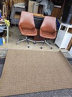 Two vintage 1970s swivel chairs placed side by side behind Karavia area rug.