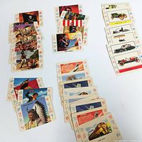 Top down view of all 34 trading cards arranged by category showing front illustrations and colors.
