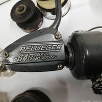 Close-up of Pflueger 640 ball bearing reel side plate showing branding and condition.