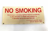 Full view of the rectangular NO SMOKING tin sign with text and mounting holes