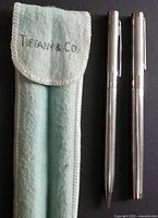 Tiffany & Co. light blue felt case next to sterling silver pen and pencil, showing pen and pencil details