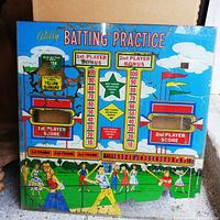 Front view of Bally Batting Practice arcade back glass showing baseball game artwork, scoreboards, and colorful flags.
