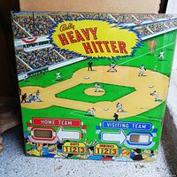 Front view of colorful Bally Heavy Hitter back glass showing baseball game scene and scoreboard