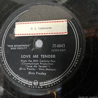 Close-up of Elvis Presley vinyl record label for 'Love Me Tender' showing RCA Victor branding and catalog number 20-6643.