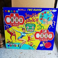 Front side of the pinball back glass showing colorful graphics with two-player score displays and theme art.