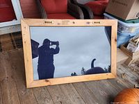 front view of wood-framed glass display case reflecting surroundings