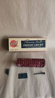Box, maroon freight car body, loose parts laid out