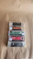 Stacked view of all five N scale freight cars in clear cases