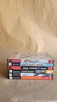 Stacked PS2 game cases showing five identifiable spines