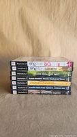 Front spines of six PS2 karaoke game cases stacked horizontally
