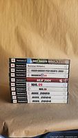Spine view of stacked PS2 sports game cases showing titles