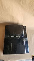 Top view of PlayStation 3 fat console showing scratched surface