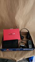 All items together in box: Evo VR box, Kobo eReader, radio headset, power cord, UK plug adapter