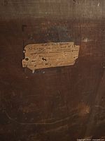 Close-up of manufacturer label on back, reading French text from Besançon workshop