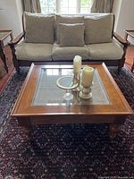 Front view of table showing rattan inset and turned legs