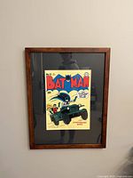 Framed Batman comic cover with wooden frame and black mat, colorful retro comic artwork.