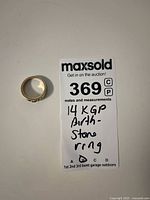 Ring placed next to MaxSold tag showing '14 KGP Birth Stone ring'