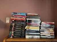 Stack of DVDs showing TV series like Supernatural, Castle, and movies including The Negotiator and The White Count.