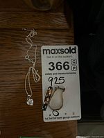 Two pairs of sterling silver earrings and a sterling silver chain with pendant marked 925 on auction tag.