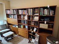 Front view of entire teak wall unit with five connected modules: open shelving sections, drawer module at center, bar cabinet module