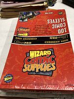 Photo of unopened package of 100 Wizard Comic Supplies current size comic sleeves, showing branding and packaging condition.