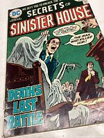 Front cover of Secrets of Sinister House #17 comic book showing dramatic courtroom ghost scene.