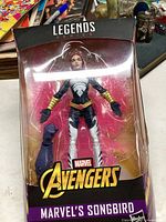 Unopened Marvel Legends Series Avengers Songbird action figure in original packaging with one extra arm accessory visible inside.