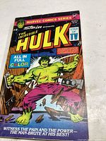 Front cover photo showing The Incredible Hulk comic book, issue #2, with colorful action art of Hulk smashing through a wooden wall.