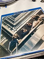 Front cover of The Beatles 1967-1970 Blue Album with photo of band members leaning over a balcony
