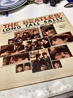 Front cover of The Beatles Long Tall Sally vinyl record showing collage of black and white images of the band and the title text.