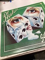 Front cover of Dr. Hook album 'Sometimes You Win' showing detailed artwork with melting dice and crying eyes.