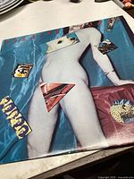 Front cover of Rolling Stones Undercover album, featuring nude art with overlapping images on blue fabric background.