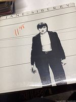 Front cover of the sealed Jane Siberry vinyl record showing black and white photo of the artist with price sticker $11.98