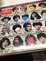 Front cover of The Rolling Stones 'Some Girls' vinyl album showing collage artwork with portraits of women and text mimicking vintage magazine advertising. Sealed in plastic wrapping.