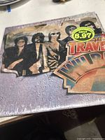 Front cover of The Traveling Wilburys vinyl album featuring the band members and album title with a price sticker.