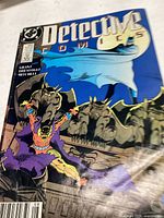 Front cover of Detective Comics issue showing a dramatic scene with Batman and gargoyle figures, mostly blue and purple color scheme.
