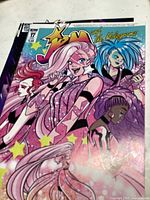 Front cover of Jem and the Holograms comic issue #17 featuring four costumed female characters including one with pink hair.