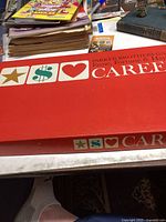 Red cardboard box of vintage Careers board game by Parker Brothers showing logo and design.