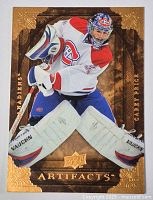 Front side of Carey Price hockey card from Upper Deck Artifacts series showing player in goalie stance with Montreal Canadiens uniform and gold foil design.