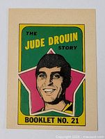 Front view of the vintage sports card featuring Jude Drouin with colorful, retro graphic design and booklet number 21.