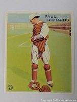 Front side of Paul Richards vintage baseball card showing player in full catcher's gear on baseball field.